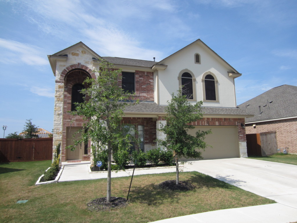 South Austin home wearing our solar window screens for all but three front windows.