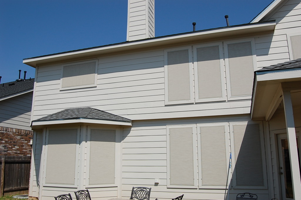 Stucco fabric solar screens Round Rock TX installation.