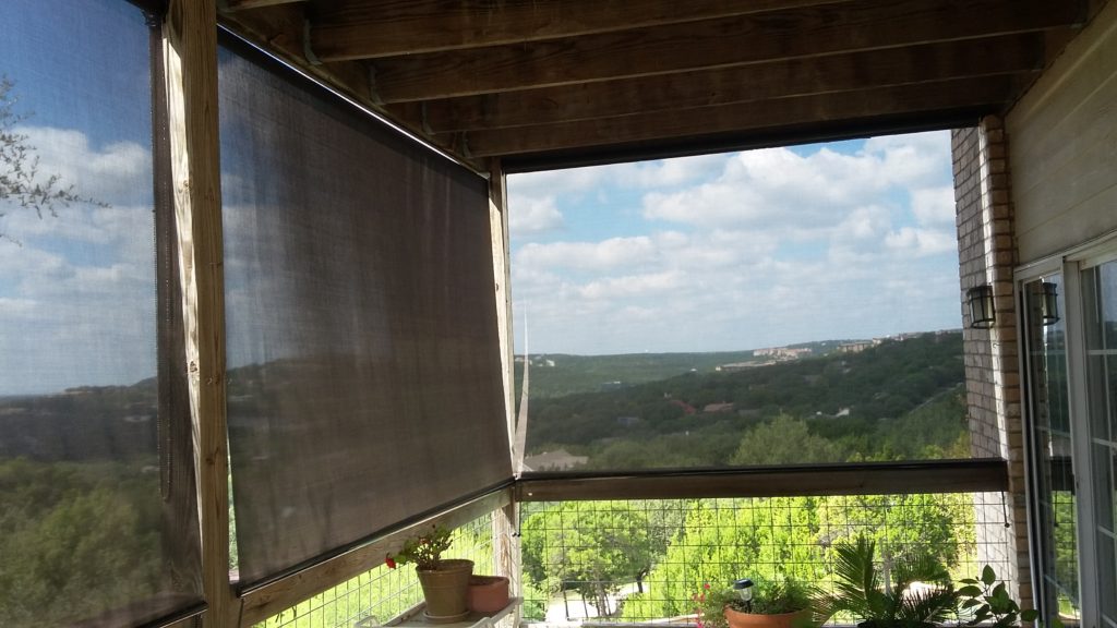 Looking out our chocolate 90% Austin TX exterior patio roller shades.