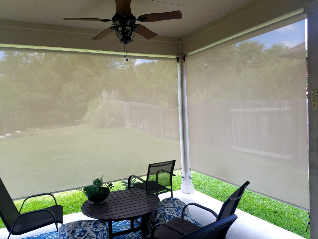 Example of looking out (through) two 97% beige / white fabric porch sun shades.