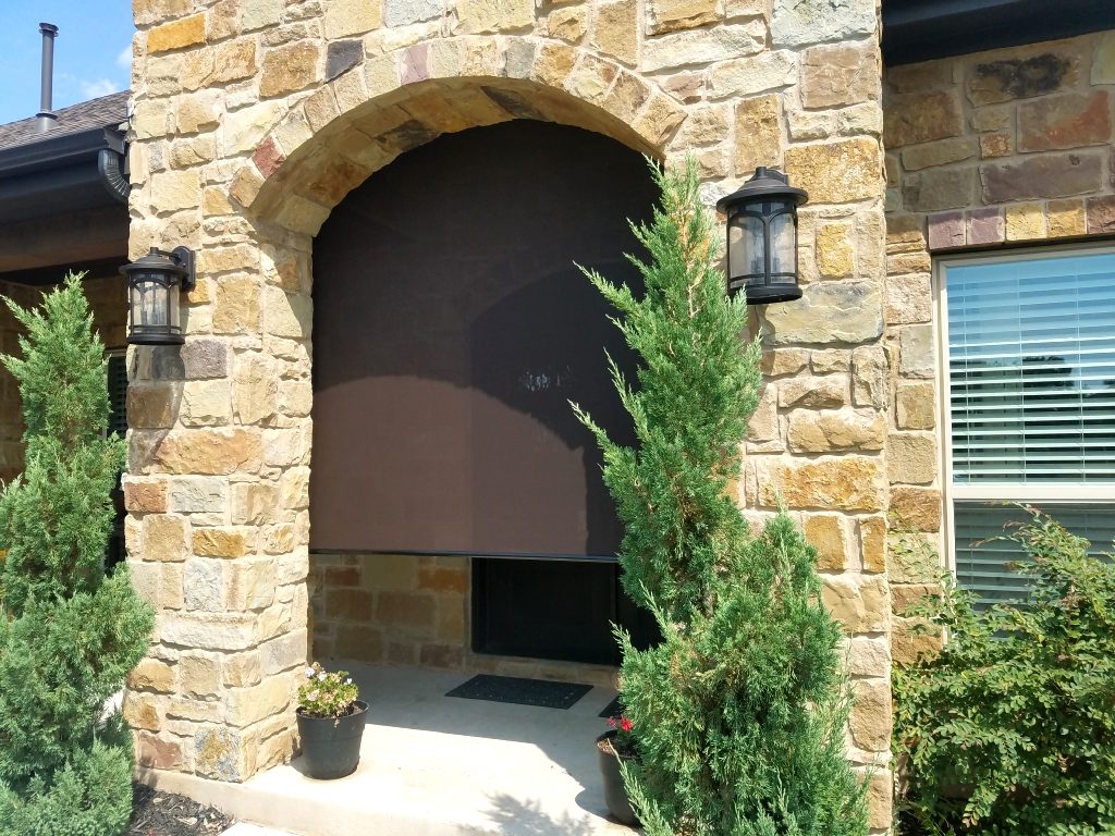 Roll up patio screen to provide sun shade for front door. This homeowner has a metal front door that use to get super hot from the sun. Not any longer, as now it is shaded with one of our patio screen sun shades.