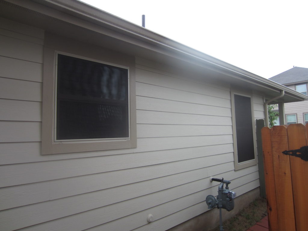 80% Austin TX vinyl installation of solar window screens for the right side.