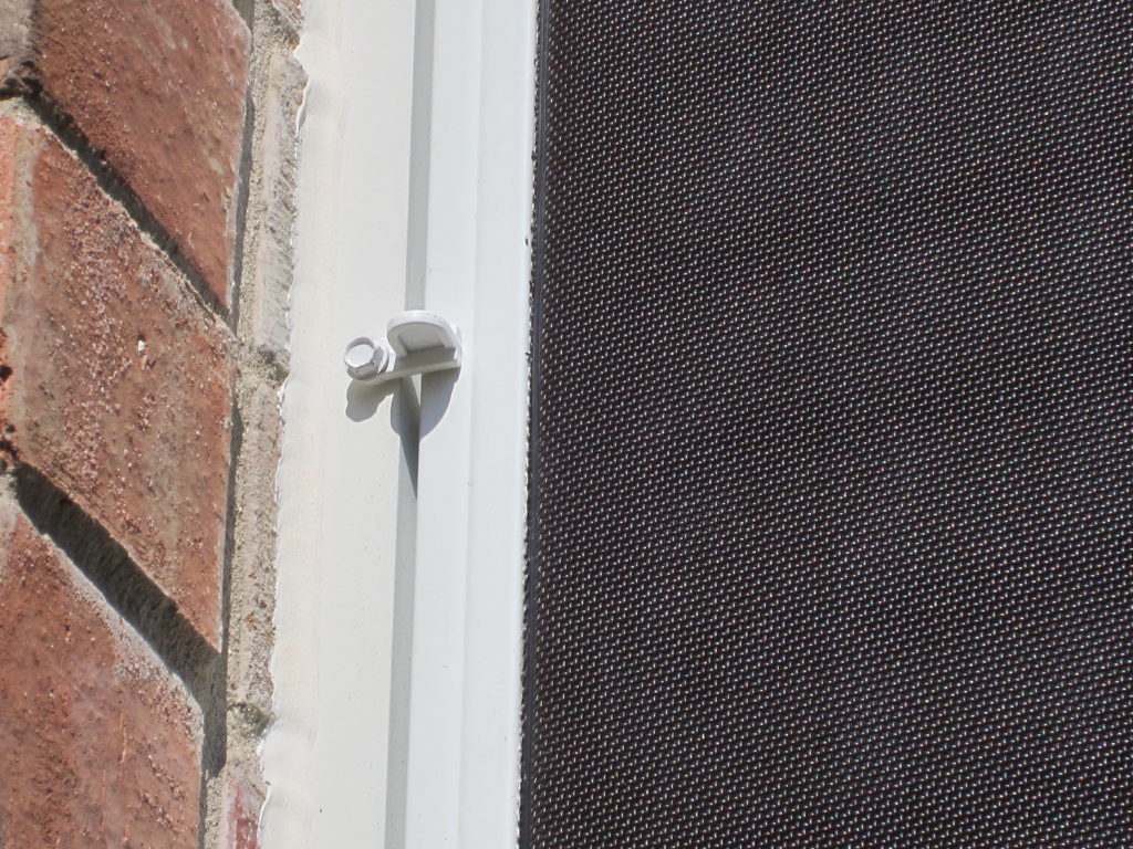 What a flush clip looks like that is put in place to keep a solar screen from coming off on its own.