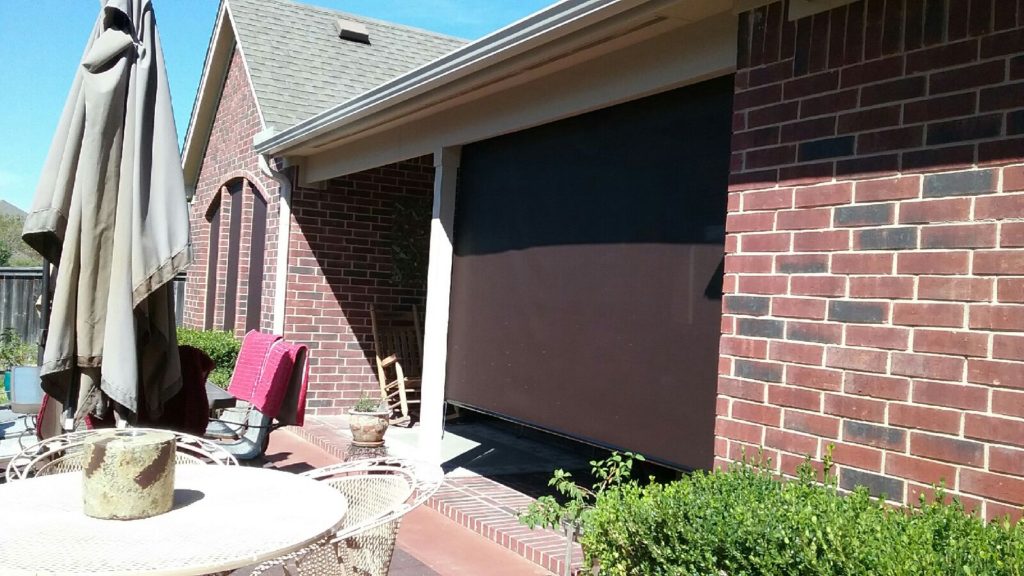 Exterior Patio Roll Shade, installed in Manor TX. Showing one roll shade in the down position.