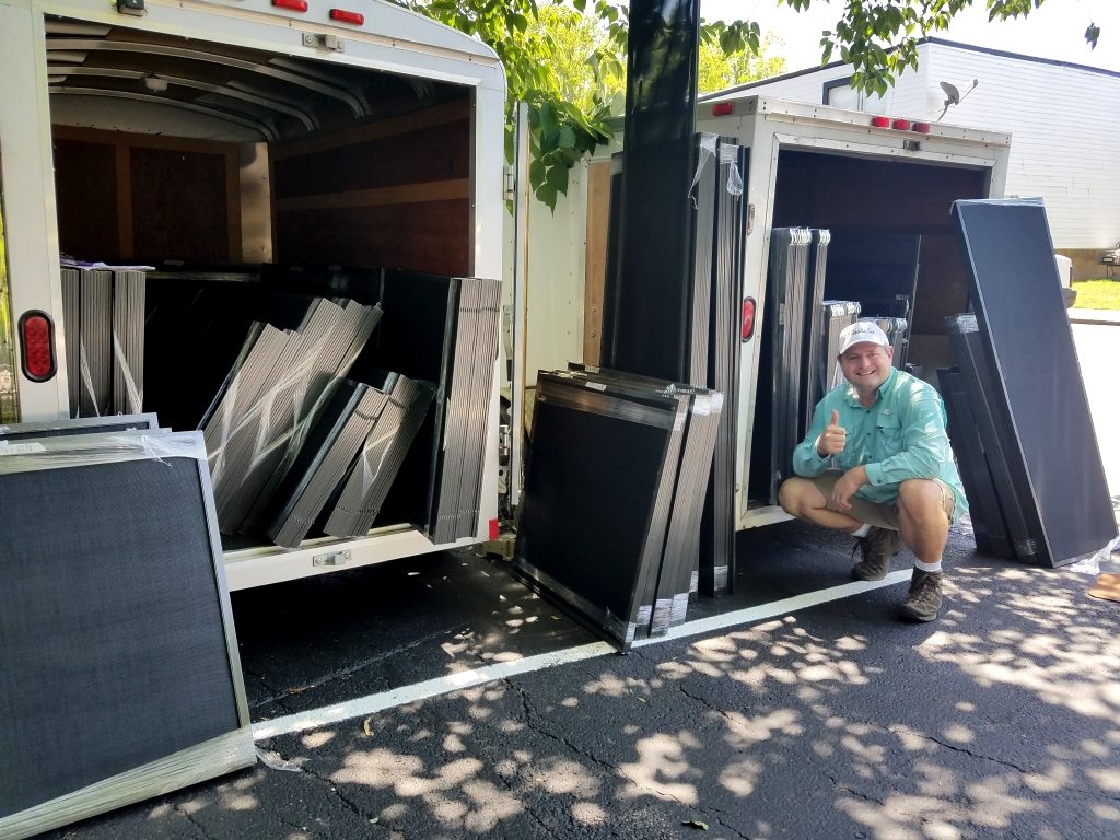 This is Josh sitting in front of trailers loaded down with solar screens for this multi-family apartment installation.